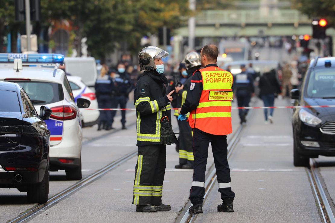 French policemen and firefighters stand guard after the attack in Nice on October 29.