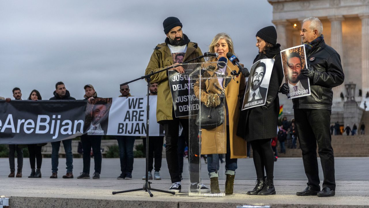 Bijan Ghaisar's mother, Kelly Ghaisar, speaks as her husband, James (right), daughter, Negeen, and son-in-law, Kouros Emami (left), stand by her during a vigil commemorating the second anniversary of Bijan's death at the Lincoln Memorial on November 17, 2019.