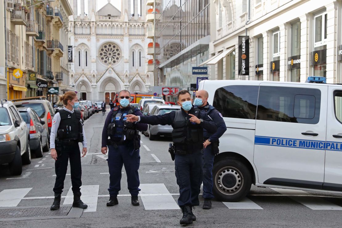 French policemen on the street leading to the Notre-Dame Basilica after the incident in Nice.