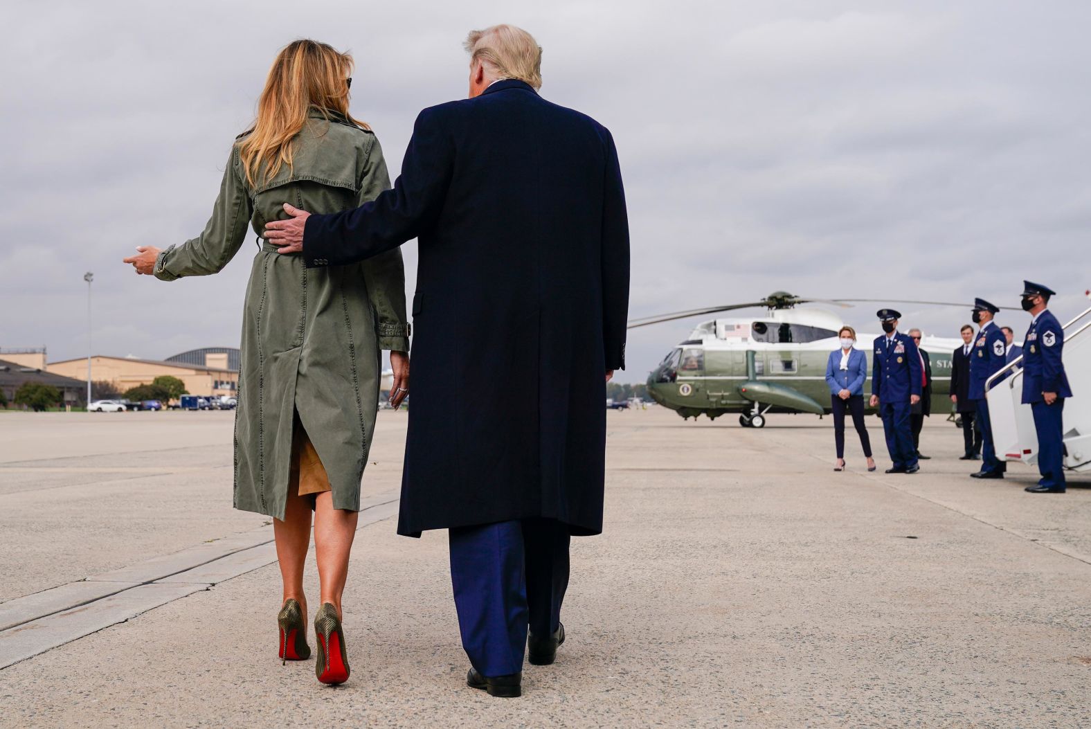 Trump walks with first lady Melania Trump after a day of campaign rallies in Michigan, Wisconsin and Nebraska in October 2020.