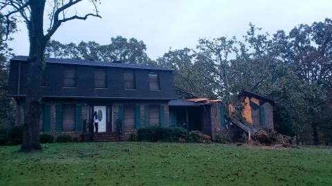 A fallen tree is seen on a home damaged by Zeta Thursday in Lincoln, Alabama.