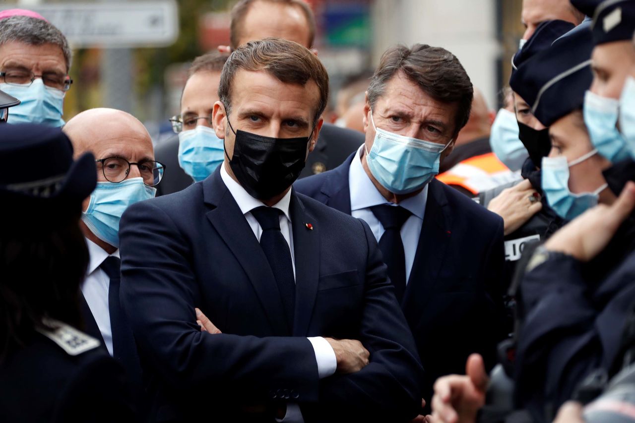 French President Emmanuel Macron, center left, and Nice Mayor Christian Estrosi, center right, visit the scene.