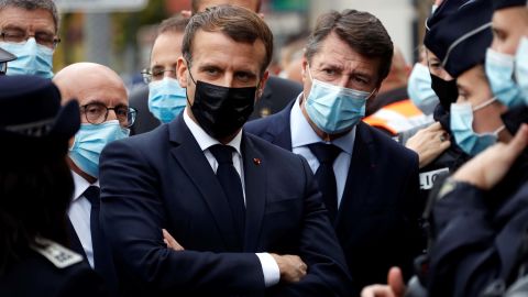 French President Emmanuel Macron, second left, visits the scene of a knife attack at a basilica in Nice on October 29, 2020, accompanied by other politicians.