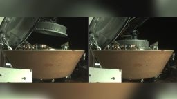 The left image shows the OSIRIS-REx collector head hovering over the Sample Return Capsule (SRC) after the Touch-And-Go Sample Acquisition Mechanism arm moved it into the proper position for capture. The right image shows the collector head secured onto the capture ring in the SRC. Both images were captured by the StowCam camera.