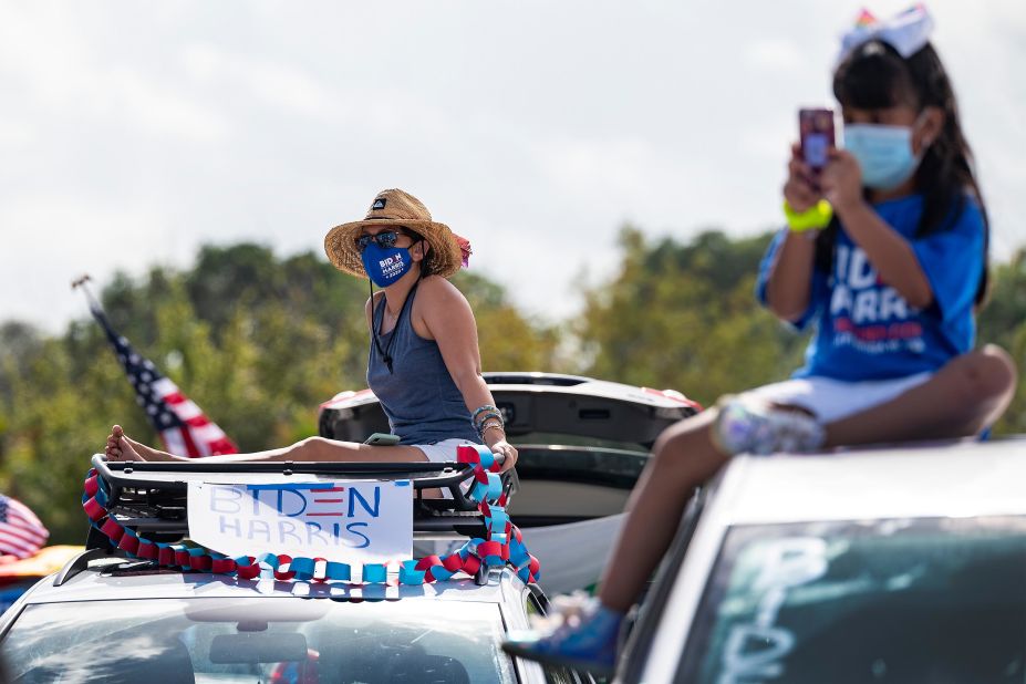 Supporters sit atop their cars as Biden speaks in Coconut Creek.