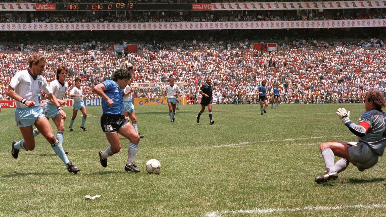Maradona runs past English defender Terry Butcher (left) on his way to beating goalkeeper Peter Shilton (right) and scoring his second goal against England in the World Cup in 1986.