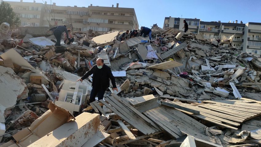 IZMIR, TURKEY - OCTOBER 30: A man walks among debris of collapsed buildings after a magnitude 6.6 quake shook Turkey's Aegean Sea coast, in Izmir, Turkey on October 30, 2020. (Photo by Mehmet Emin Menguarslan/Anadolu Agency via Getty Images)
