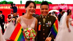 Newly-wedded same-sex couple Yi Wang (R) and Yumi Meng pose for a photograph during a mass wedding at Taiwan's Army Command Headquarters in Taoyuan on October 30, 2020, where two Taiwanese soldiers and their civilian same-sex partners tied the knot marking another gay rights landmark in Asia. (Photo by Sam Yeh / AFP) (Photo by SAM YEH/AFP via Getty Images)