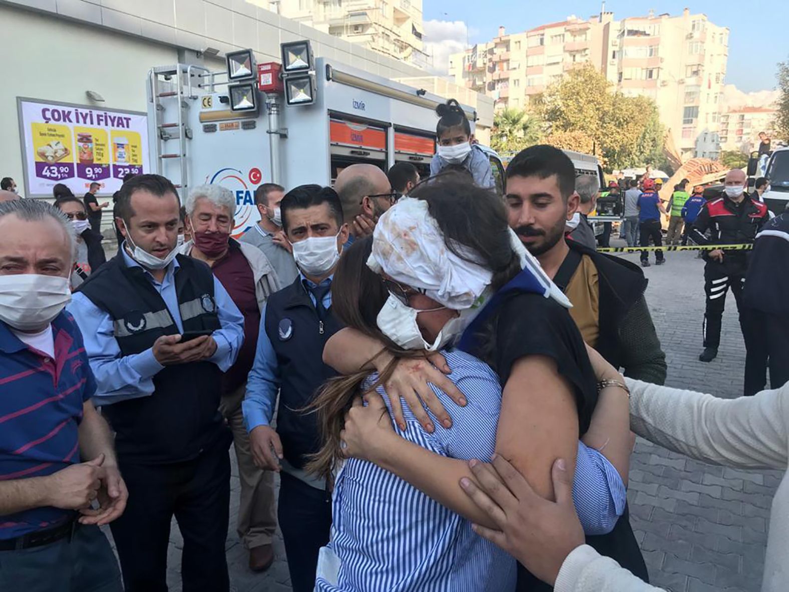 A wounded woman hugs a relative after being rescued from a building in Izmir.