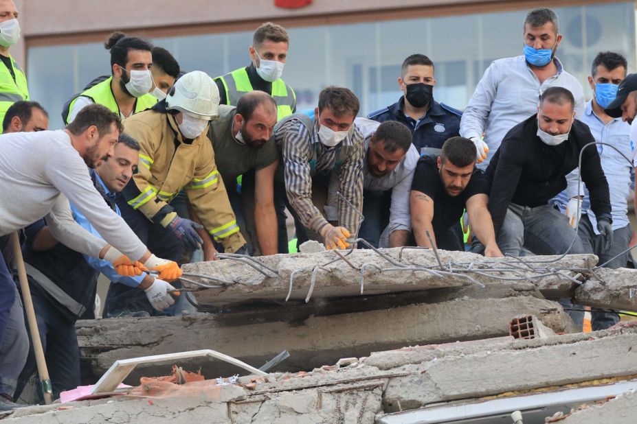 Rescue crews move rubble in Izmir.