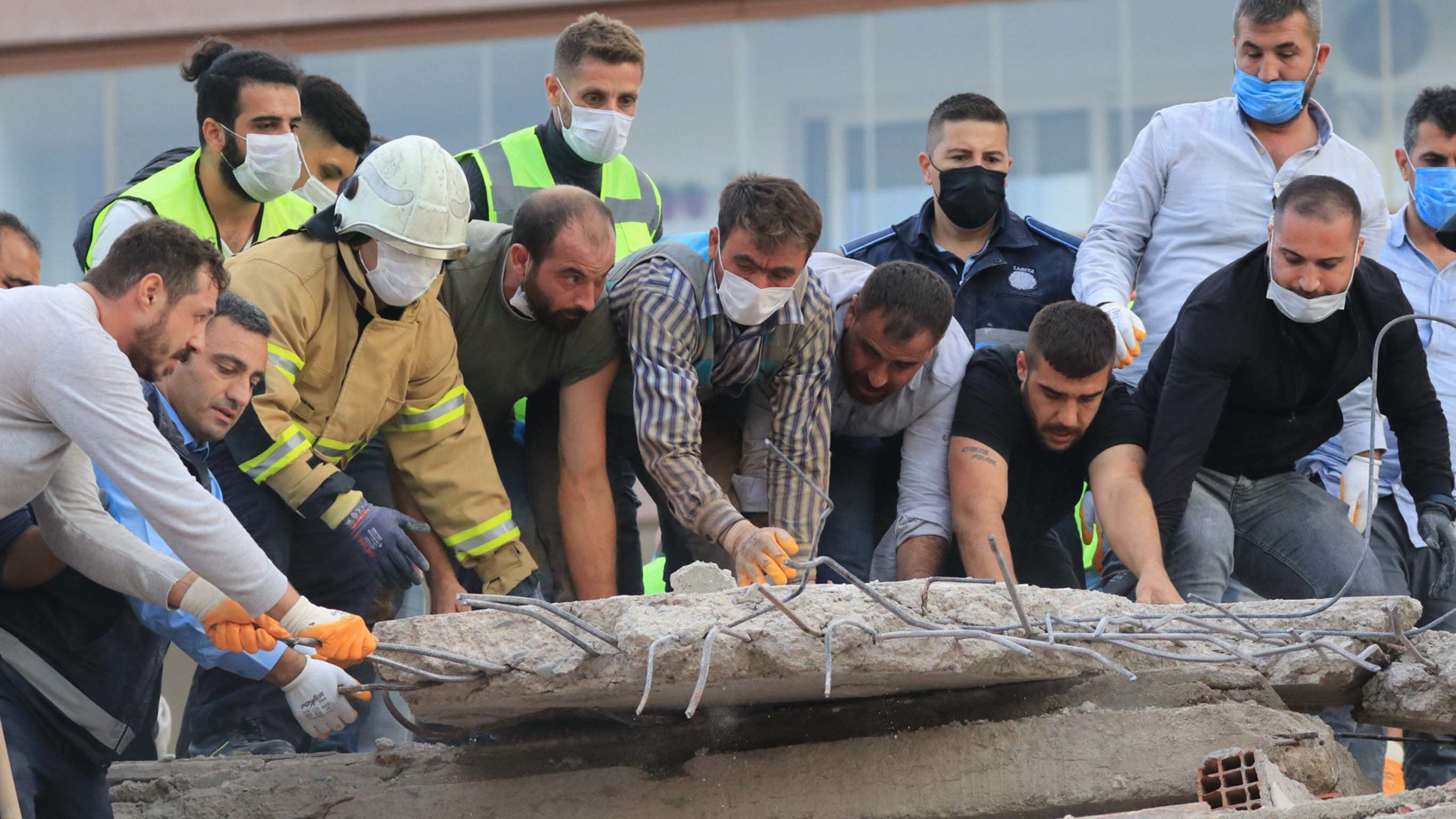 Rescue crews move rubble in Izmir.