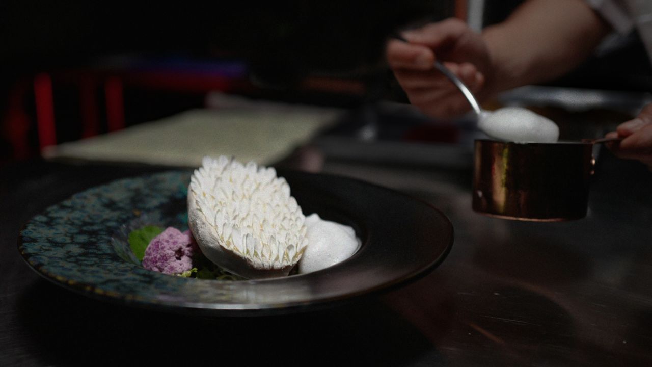 Kittibanthorn created the protein as part of his master's degree in future materials at London's Central Saint Martins art school. Here, he pays homage to the protein's origin by creating a white feather meat "wing" served with truffle foam, roasted purple cauliflower, malabar spinach and ruby corn.