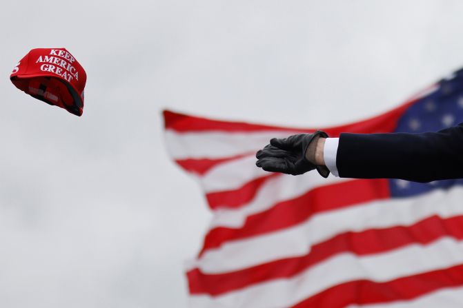 Trump tosses out caps as he arrives for a campaign rally in Waterford Township, Michigan, on October 30.