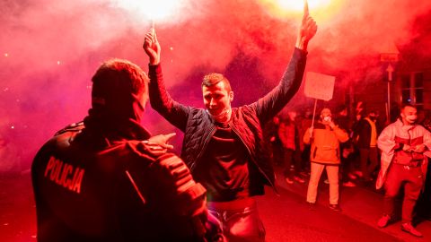 A demonstrator in Warsaw holds flares as hundreds of thousands took to the streets this week to voice their opposition to the tightening of Poland's abortion law.
