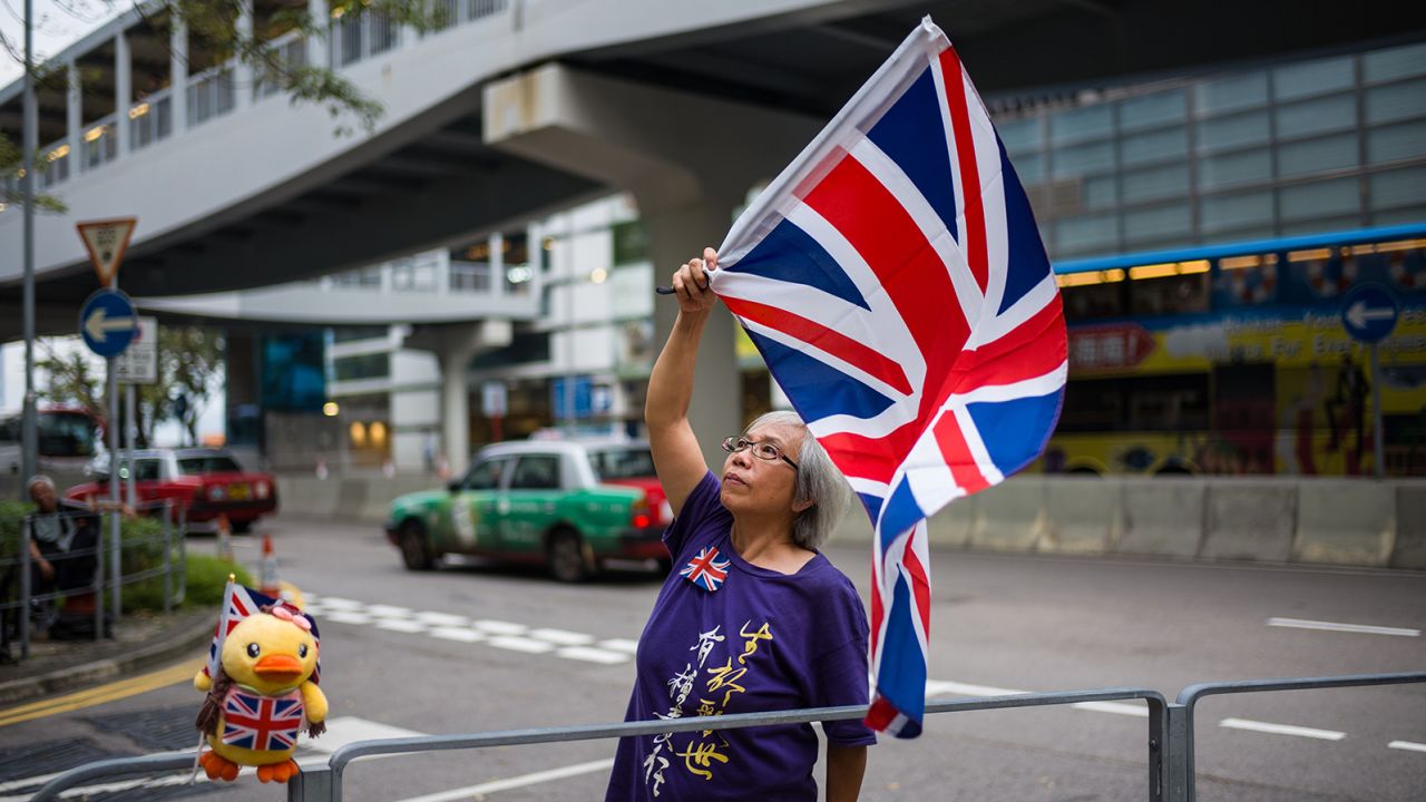 Activist Alexandra Wong waves a British Union Jack flag during a gathering outside the government headquarters to mark the fourth anniversary of mass pro-democracy rallies, known as the Umbrella Movement, in Hong Kong on September 28, 2018.