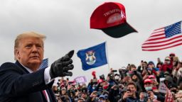 President Donald Trump tosses a cap during a campaign stop in Waterford Township, Mich., Friday Oct. 30, 2020. 