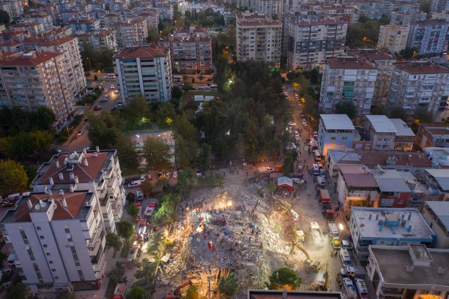 Emergency workers search a collapsed building for survivors in Izmir.