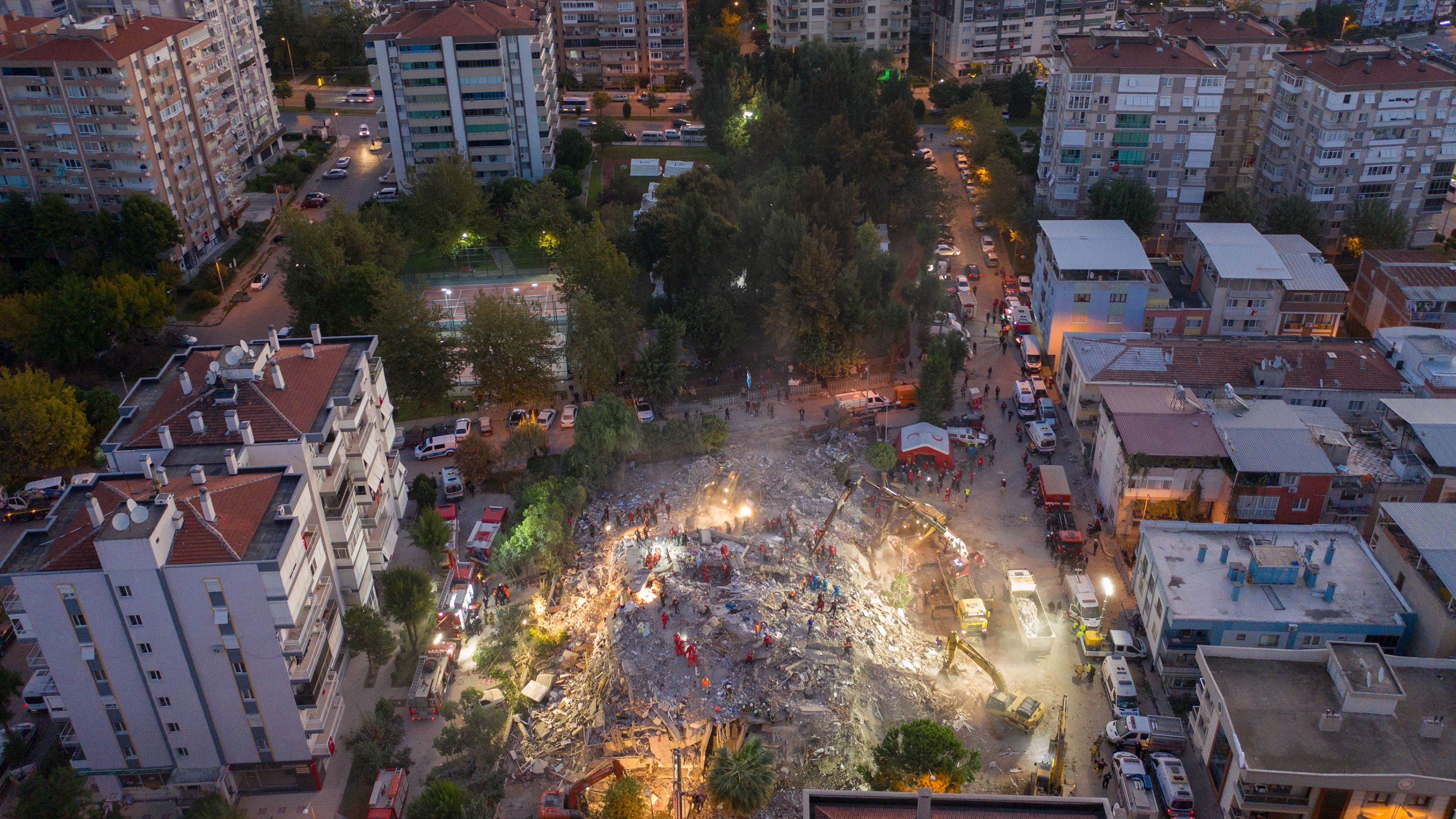 Emergency workers search a collapsed building for survivors in Izmir.