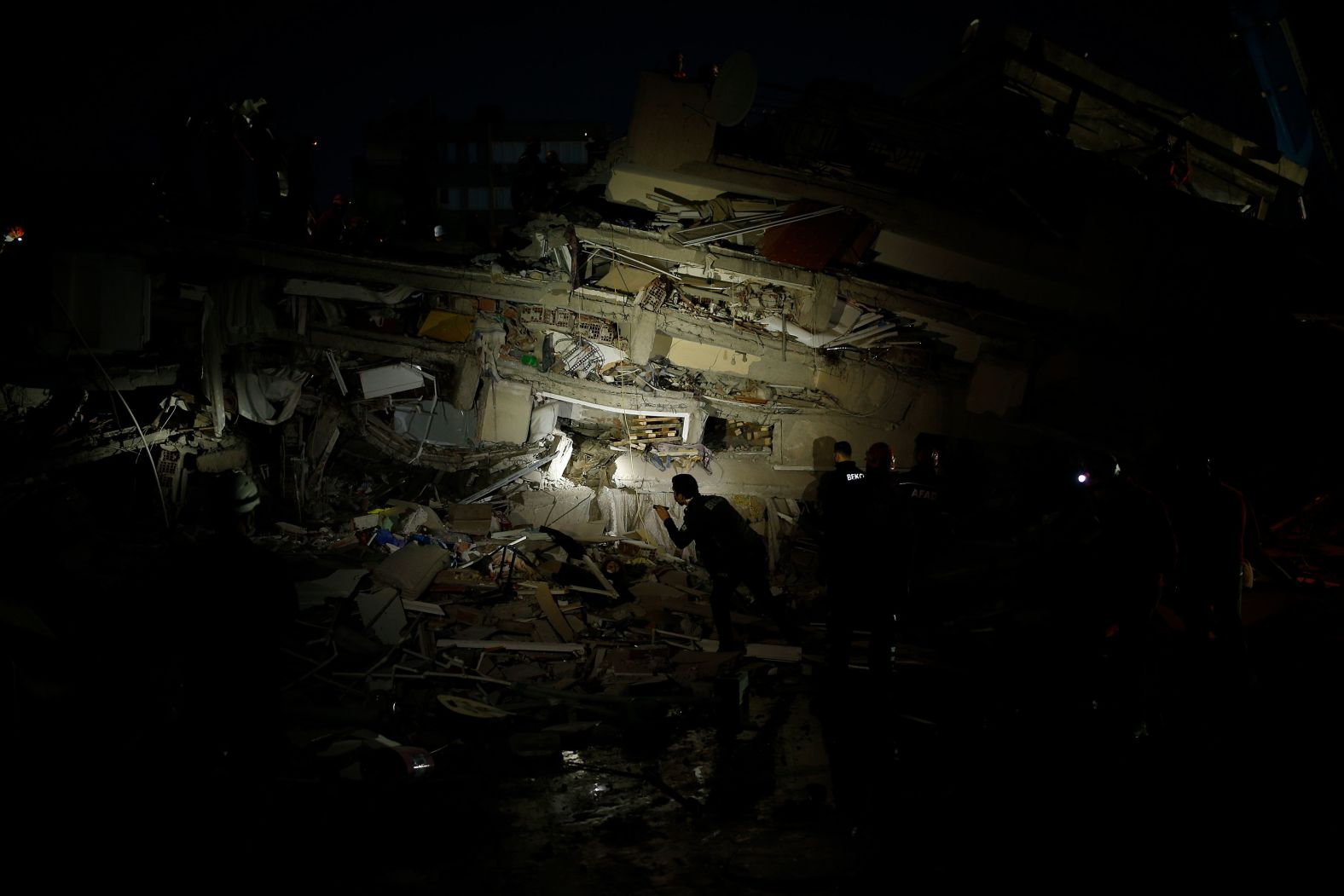 Rescue workers search for survivors in the debris of a collapsed building in Izmir.
