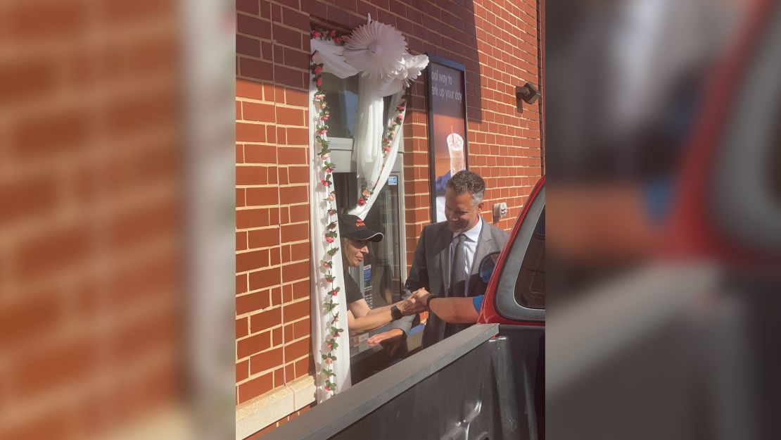 Good and Thompson exchanging vows and getting married through the drive-thru.