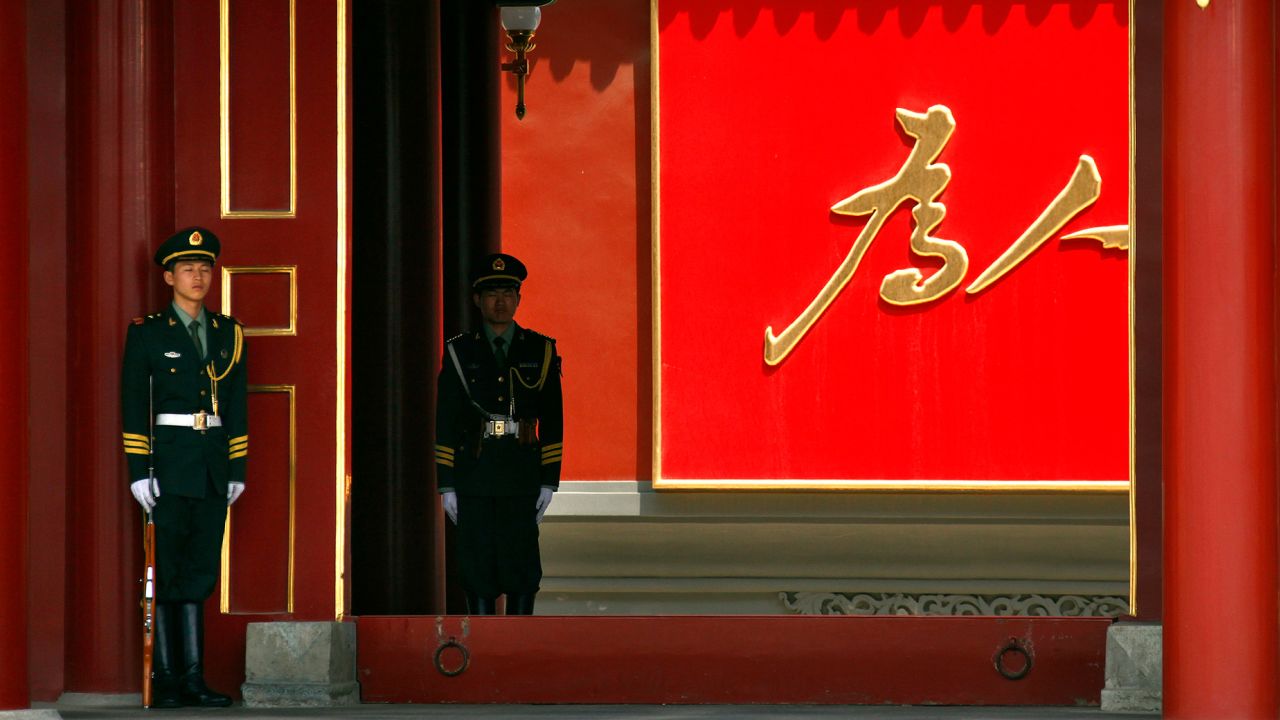 Paramilitary guards stand outside the Xinhua Gate of the Zhongnanhai leadership compound.