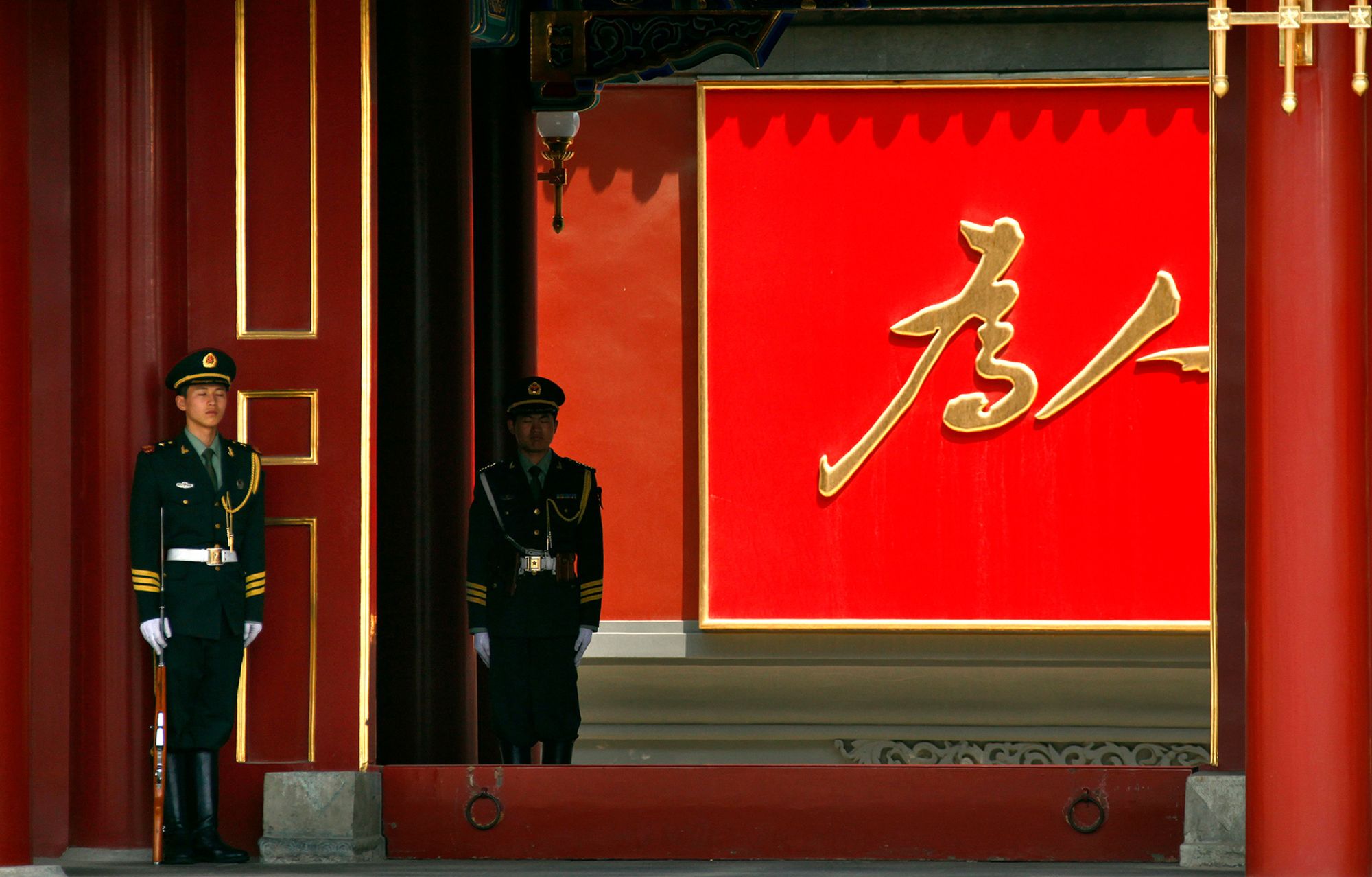Paramilitary guards stand outside the Xinhua gate of Zhongnanhai in Beijing on May 25, 2011.