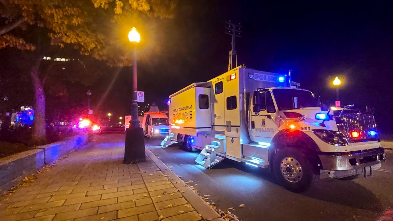 A Police truck is parked near the National Assembly of Quebec, in Quebec City,  after two people were killed and five wounded by a suspect now in custody. 