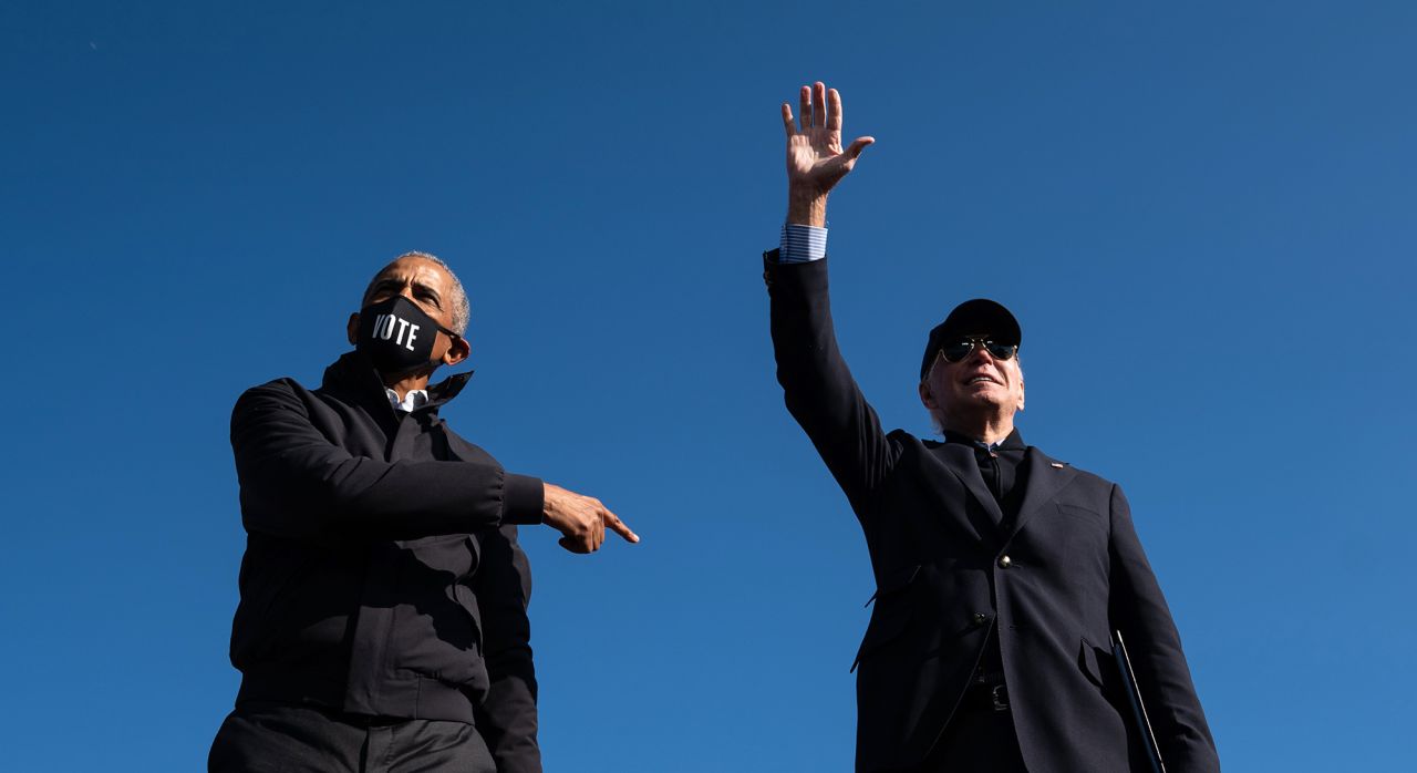 Former President Barack Obama points to Biden after speaking at a drive-in rally in Flint, Michigan, on October 31. 