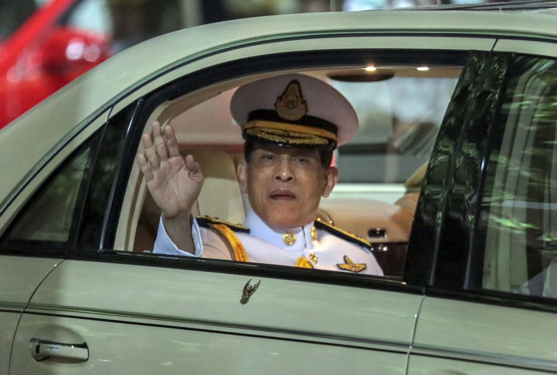 Thailand's King Maha Vajiralongkorn waves from his limousine after officiating a graduation ceremony at Bangkok's Thammasat University on October 31, 2020. 
