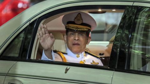 Thailand's King Maha Vajiralongkorn waves from his limousine after officiating a graduation ceremony at Bangkok's Thammasat University on October 31, 2020.
