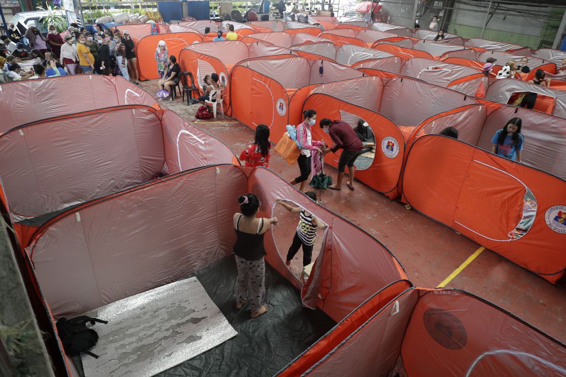 Residents occupy an evacuation center as rains start to pour in Manila, Philippines on Sunday.