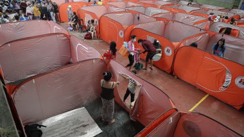 Residents occupy an evacuation center as rains start to pour in Manila, Philippines on Sunday.