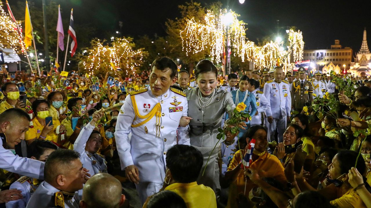 Thailand's King Maha Vajiralongkorn and Queen Suthida greet royalist supporters outside the Grand Palace in Bangkok on November 1, 2020 after presiding over a religious ceremony at a Buddhist temple inside the palace. (Photo by Jack TAYLOR / AFP) (Photo by JACK TAYLOR/AFP via Getty Images)