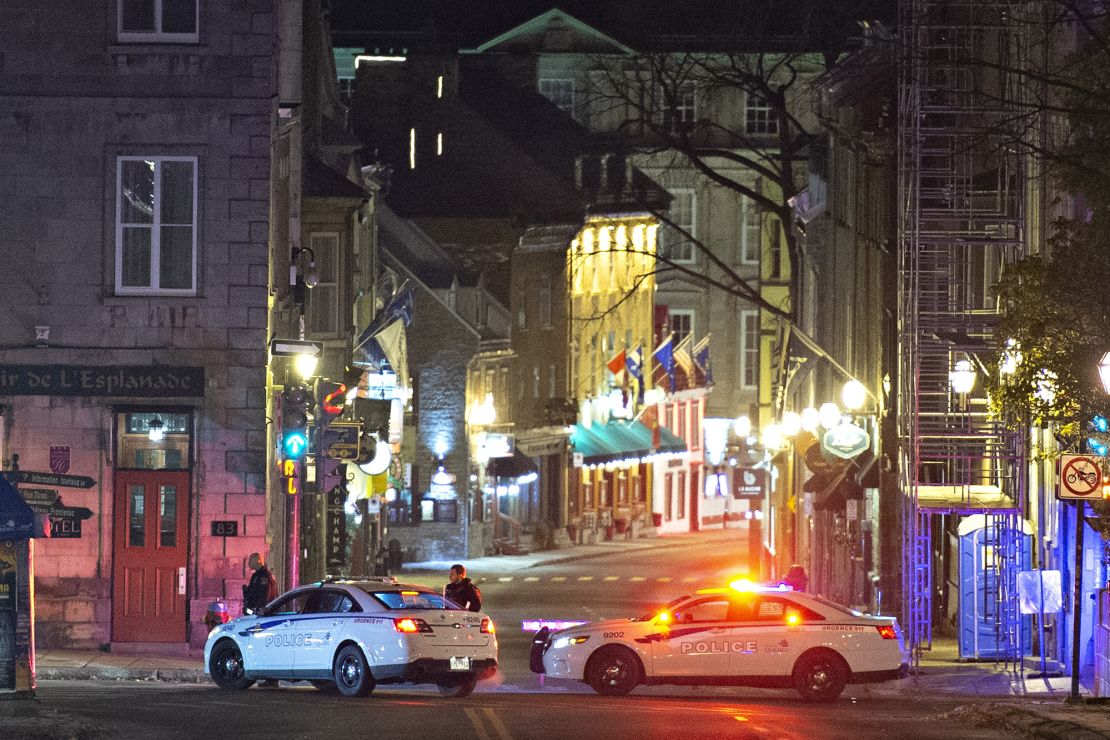 Police cars block the Saint-Louis Street near the Chateau Frontenac early Sunday, Nov. 1, 2020 in Quebec City, Canada.