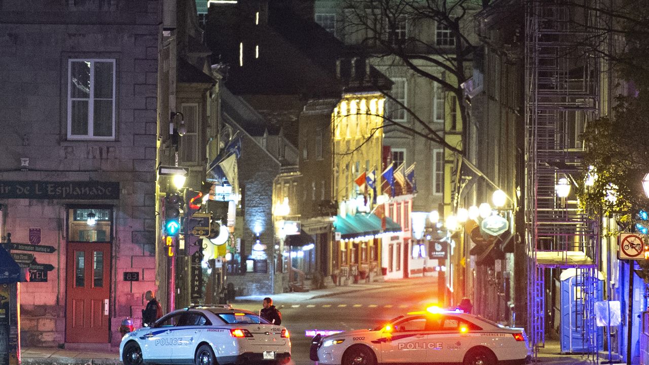 Police cars block the Saint-Louis Street near the Chateau Frontenac early Sunday, Nov. 1, 2020 in Quebec City, Canada.