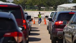HOUSTON, TX - OCTOBER 07: An election worker guides voters in cars at a drive-through mail ballot drop-off site at NRG Stadium on October 7, 2020 in Houston, Texas. Gov. Gregg Abbott issued an executive order limiting each county to one mail ballot drop-off site due to the pandemic. (Photo by Go Nakamura/Getty Images)