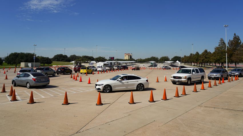 HOUSTON, TX - OCTOBER 07: Voters in cars line up at a drive-through mail ballot drop-off site at NRG Stadium on October 7, 2020 in Houston, Texas. Gov. Gregg Abbott issued an executive order limiting each county to one mail ballot drop-off site due to the pandemic. (Photo by Go Nakamura/Getty Images)