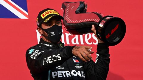 Hamilton holds his trophy as he celebrates on the podium after the Emilia Romagna GP.
