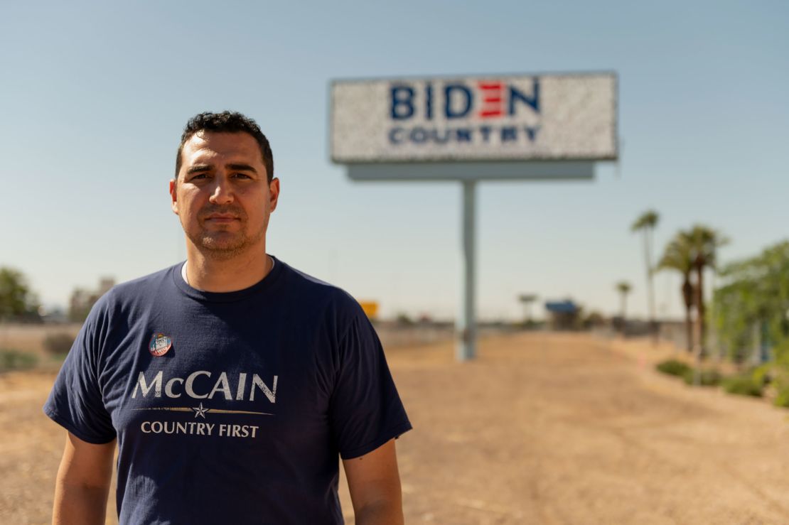 Yasser Sanchez stands in front of a billboard he funded off the side of Interstate 10 in Phoenix.