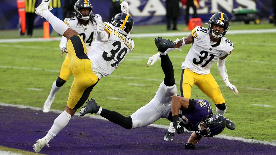 Free safety Minkah Fitzpatrick #39 and cornerback Justin Layne #31 of the Pittsburgh Steelers hit wide receiver Willie Snead #83 of the Baltimore Ravens on the last play of the game during the Steelers 28-24 win.