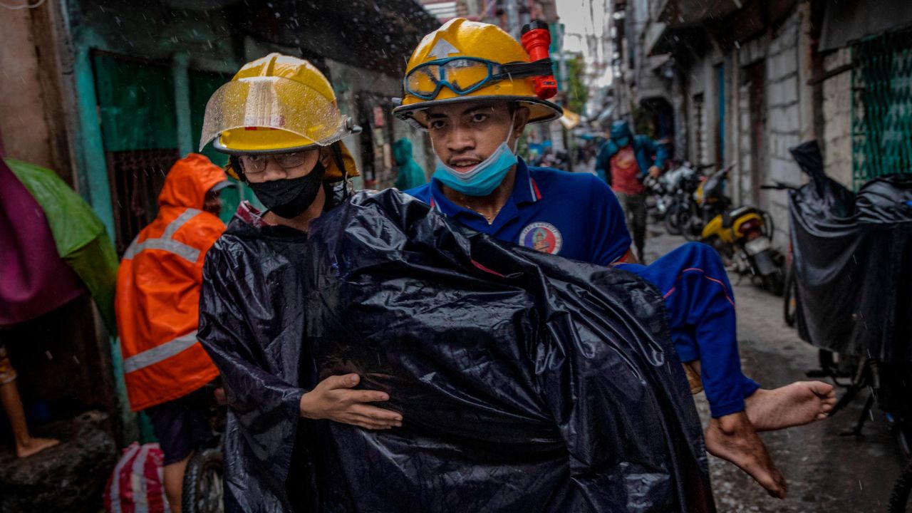 Rescue workers carry a sick person as they evacuate before Typhoon Goni hits on November 1 in Manila, Philippines.
