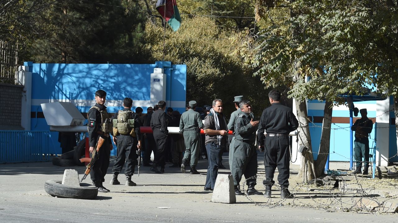 Policemen stand guard at an entrance gate to Kabul University on Monday.