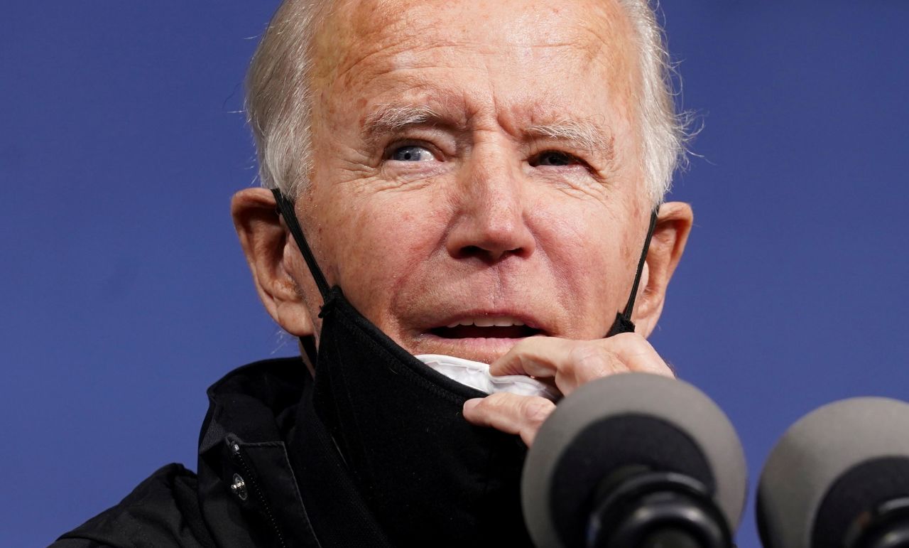Biden pulls down his face mask as he speaks in Philadelphia on November 1.