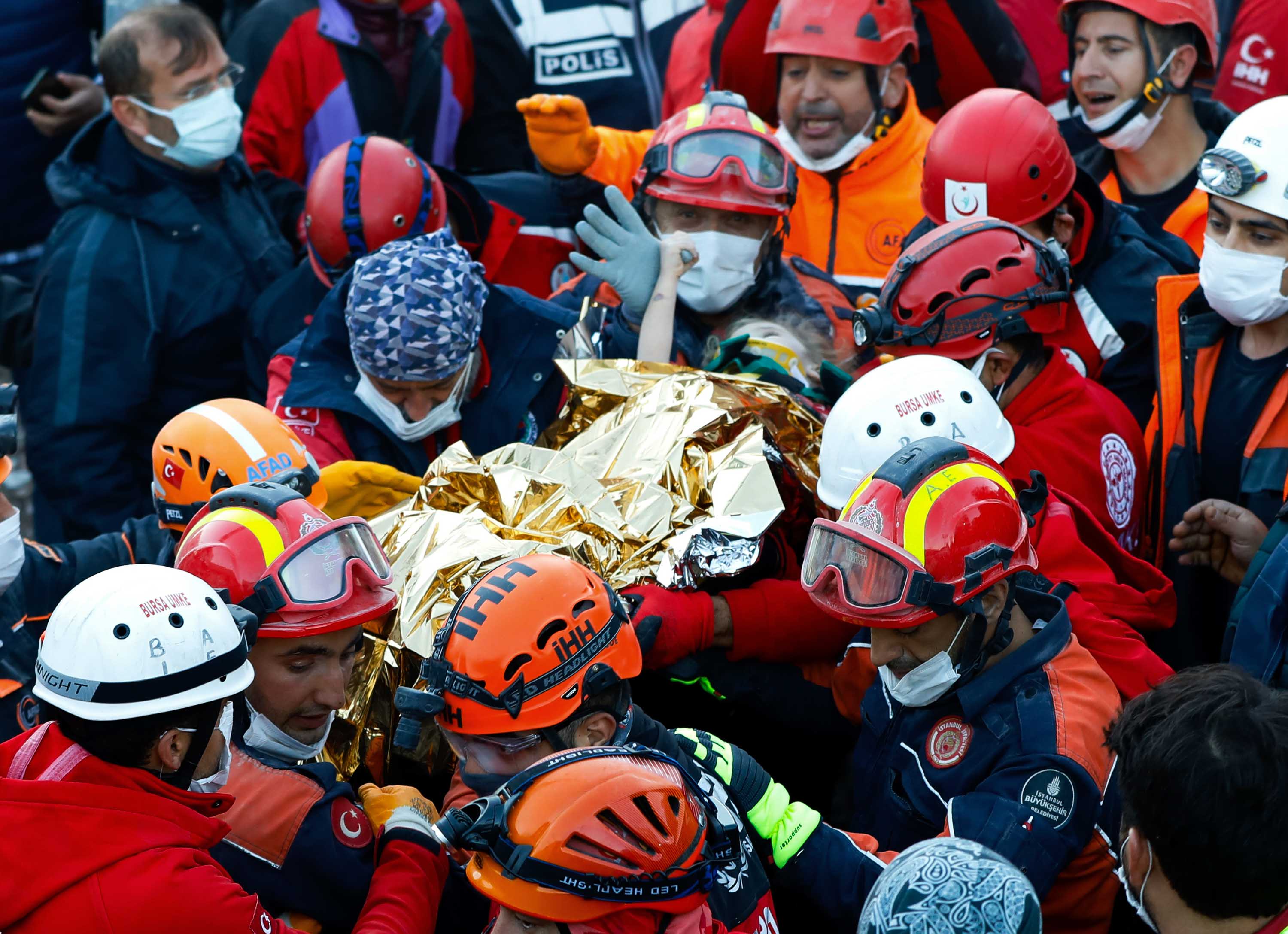 Rescuers carry 3-year-old Elif Perincek after she was rescued from the rubble of a building in Izmir, Turkey, on Monday, November 2.