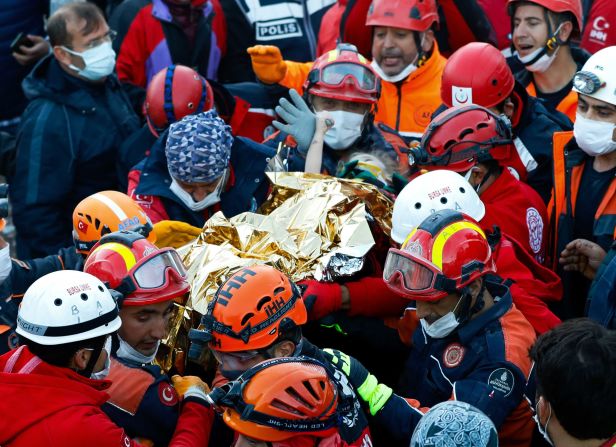 Rescuers carry 3-year-old Elif Perincek after she was rescued from the rubble of a building in Izmir, Turkey, on Monday, November 2.