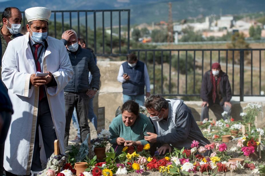 An imam prays in Izmir as people attend the November 1 funeral of Bayram and Hatice Dogruya, a married couple killed in the earthquake.