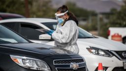 An attendant talks to a person waiting in their car at a coronavirus testing site at October 31 in El Paso, Texas.