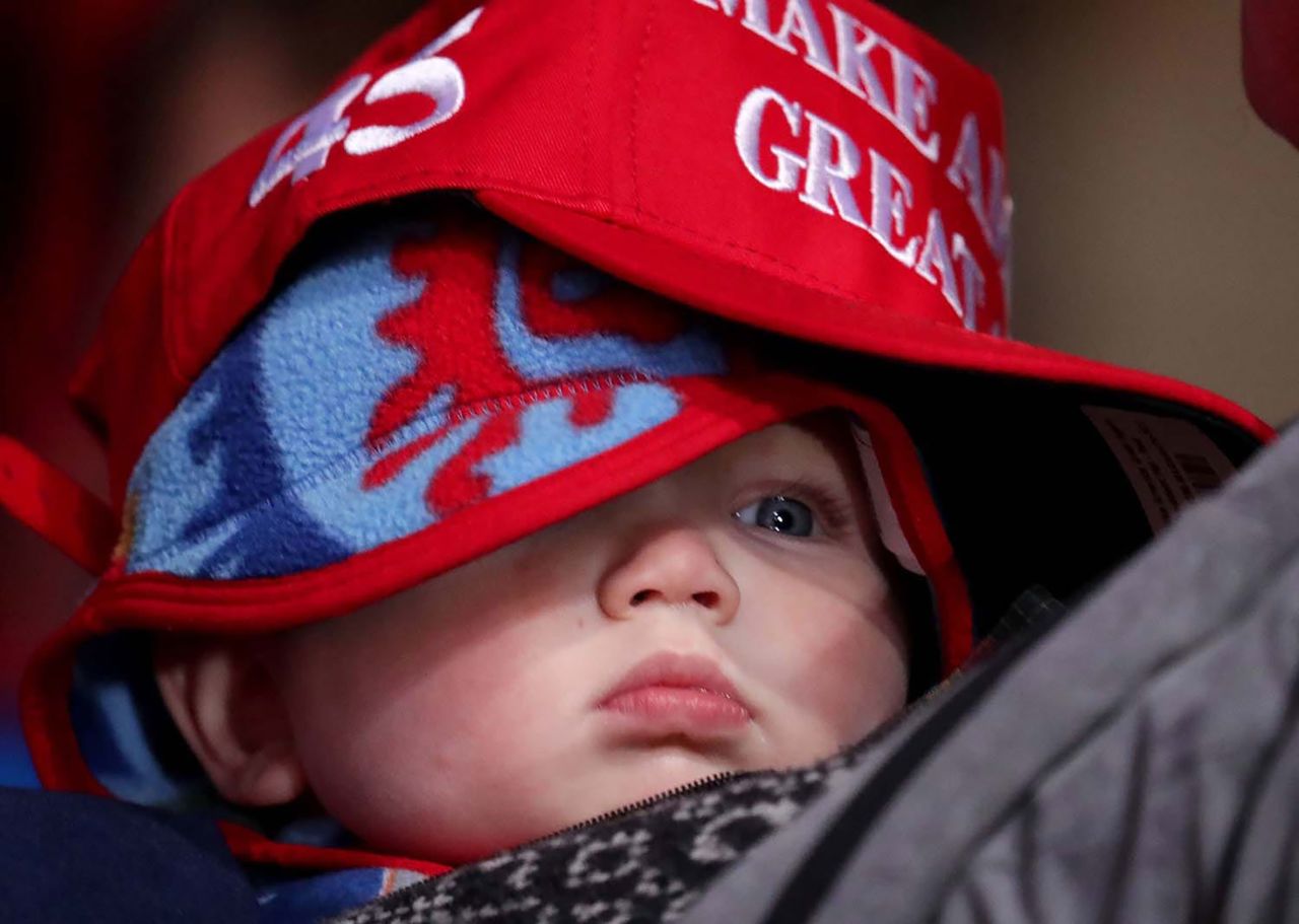 A bundled-up baby wears a "Make America Great Again" hat at Trump's rally in Kenosha, Wisconsin, on November 2. 