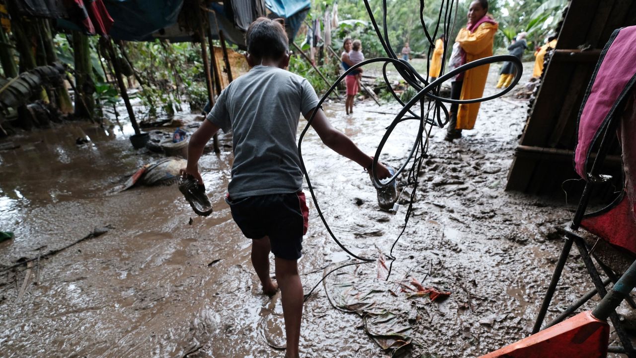 In Honduras, villagers of Bordo del Lancetilla repair their houses Tuesday after the Lancetilla River flooded during heavy rains from Hurricane Eta.