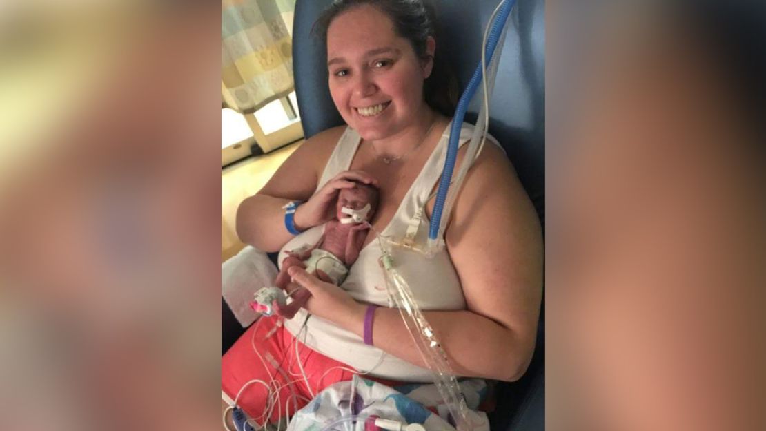 Valerie holds Logan in the hospital. 